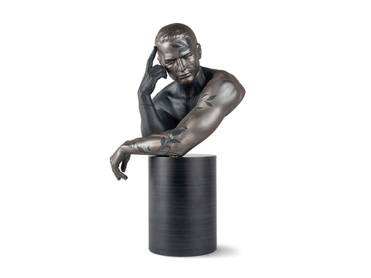 A dark grey bust of a man leaning on his arms in a metallic and matte finish with leaves across the metallic parts
