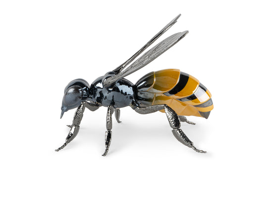 a sculpture in the shape of a bee with metal legs and wings, with a porcelain body in grey, yellow and black
