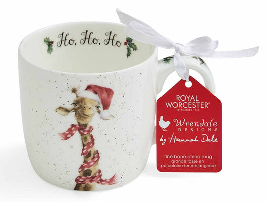 A white china mug with a giraffe wearing a red scarf and Santa hat on the front