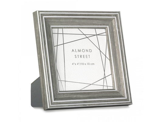 A dark grey moulded photo frame with white detailing