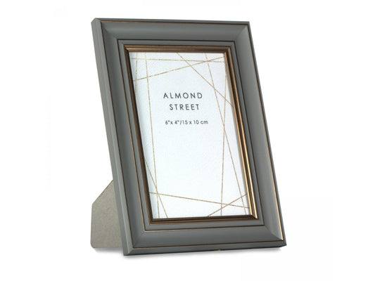 A dark grey moulded photo frame with copper details
