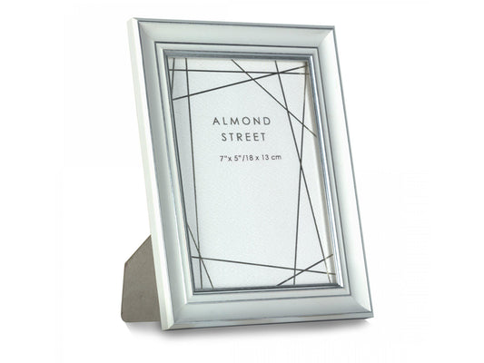A large white and silver moulded frame