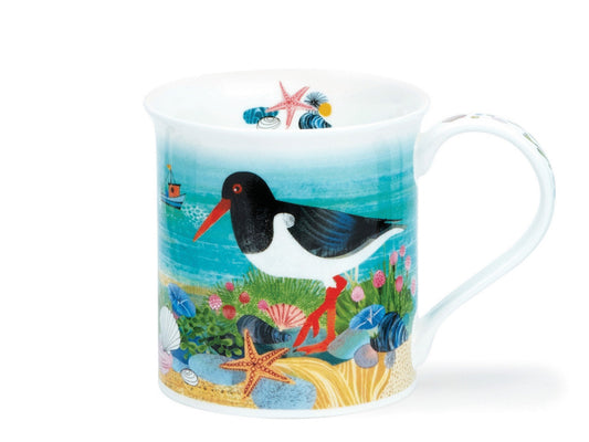 A fine bone china mug featuring vibrant illustrations of Oystercatcher birds by a sandy shore. Complete with coastal plants, rocks, shells, and turquoise waters. The handle showcases alternating coastal motifs of shells and plants, while the inner rim displays a colourful array of shells surrounding a starfish.