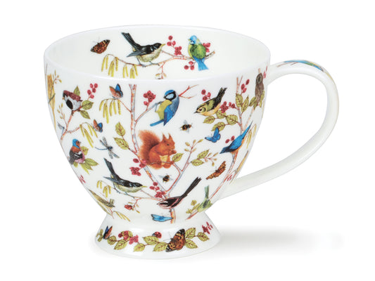 A white china cup covered in bright birds and woodland creatures amongst tree branches