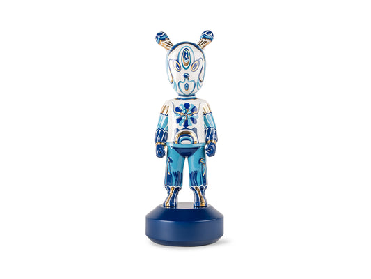 A faceless figure on a dark blue base with small antenna coming out of it's head like Shrek's ears, decorated in intricate blue, white and gold patterns