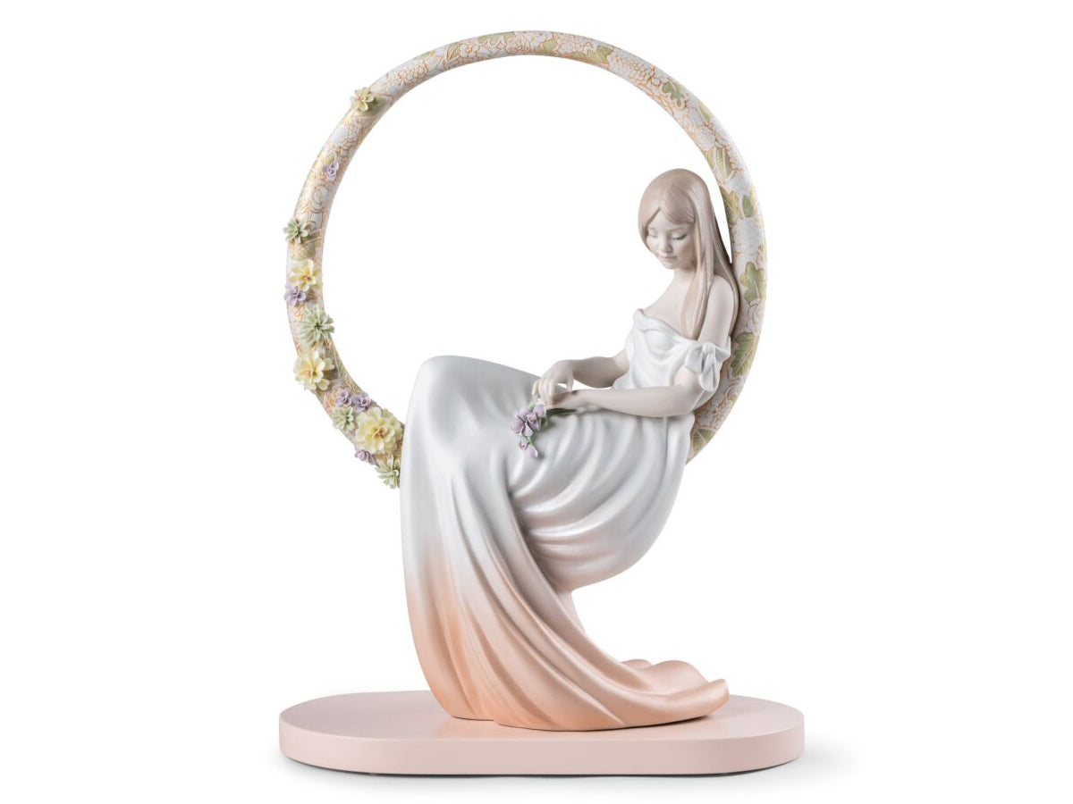Lladro porcelain figurine of a woman sitting amonst the flowers