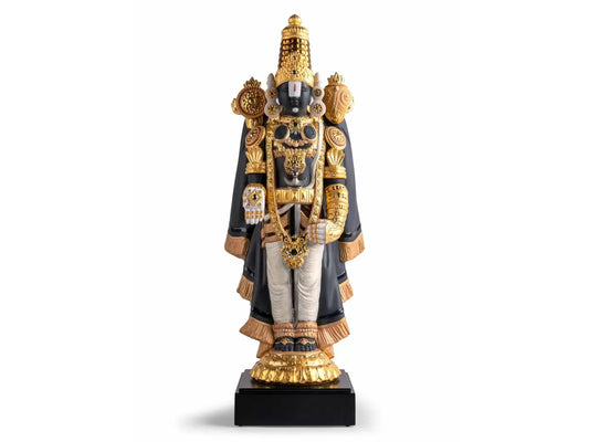 a porcelain figure of the Hindu deity Lord Balaji, who is dressed in ornate robes with heavy gold detailing, including a blue cape.