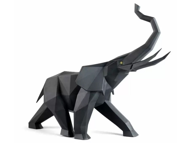 A black geometric elephant statue with yellow eyes, walking with its trunk in the air.