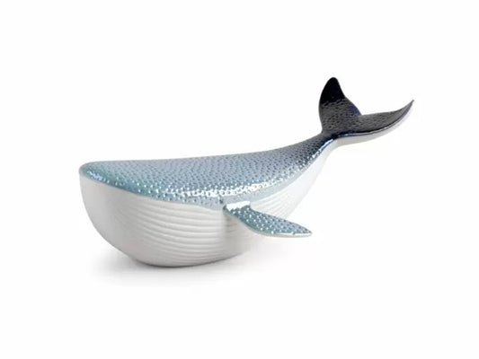 A stylised sculpture of a whale with a ribbed white matte belly and a pearly blue dotted top