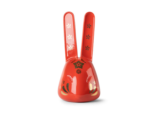 A stylised rabbit's head in red glaze and gold details