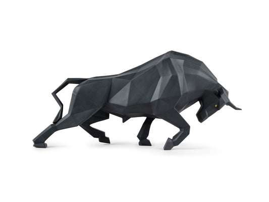 A matte black origami bull figure that is charging with its head down
