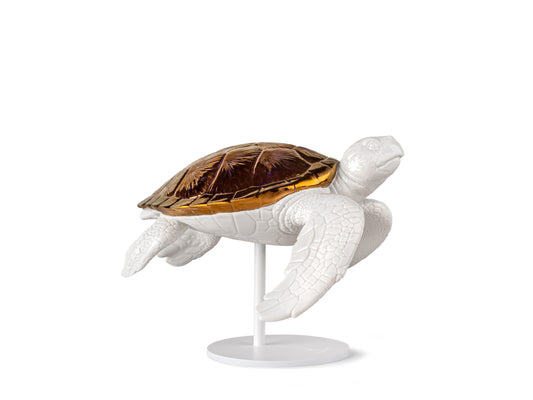 A white glazed porcelain turtle sculpture with its flippers down and a copper shell