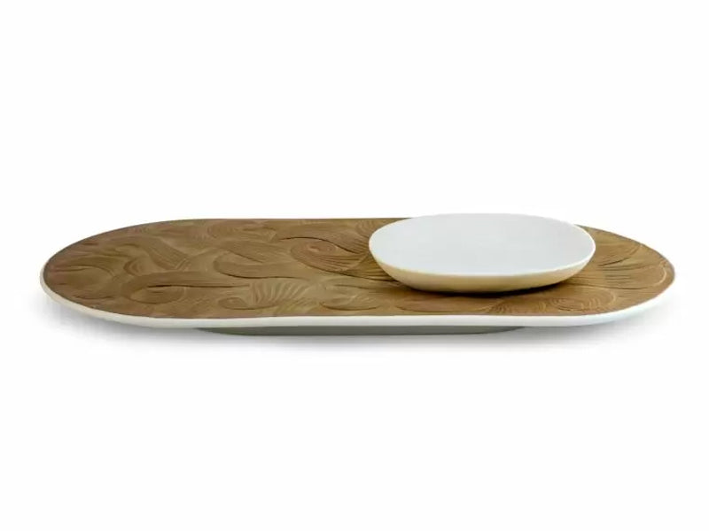 A white and gold tray with a smaller round dish on one side, carved with flame-shaped designs.