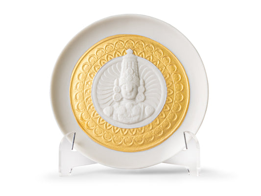A white and gold plate with a carved design of Lord Balaji in the centre
