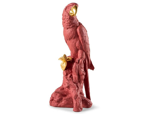 Lladró's skilled artists have adorned this vibrant porcelain macaw with intricate coral red and golden luster accents.