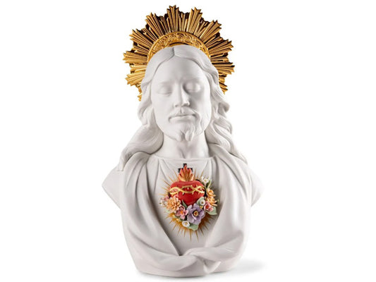 creation in matte white porcelain beautifully accentuates the serenity of Jesus's countenance and the vivid red heart at the core of His chest. True to tradition, the heart is encircled by a crown of thorns, accompanied by purifying flames and the cross of redemption. In this rendition, we've introduced a floral arrangement, symbolizing the renewal of life.