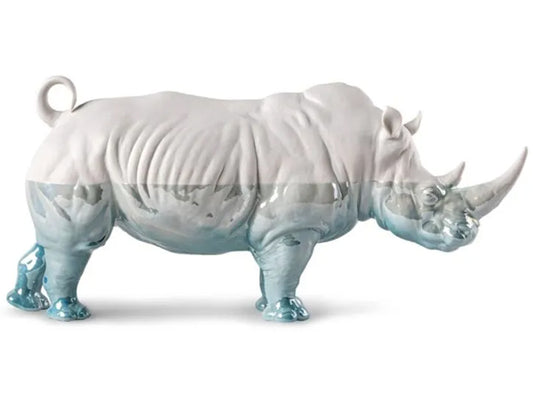 This artwork is a highlight from the Lladro Underwater Collection, paying homage to animal life and water. A White Rhino made from porcelain, it serves as a conduit to nature through artistic expression. Employing unique techniques, it seamlessly merges the animal world with natural elements, highlighted by mesmerizing blue tones that evoke immersion.