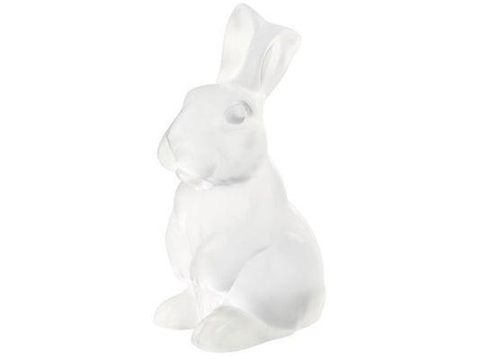 A clear crystal figurine of a rabbit sat on its back legs, with its front paws resting in front of it.