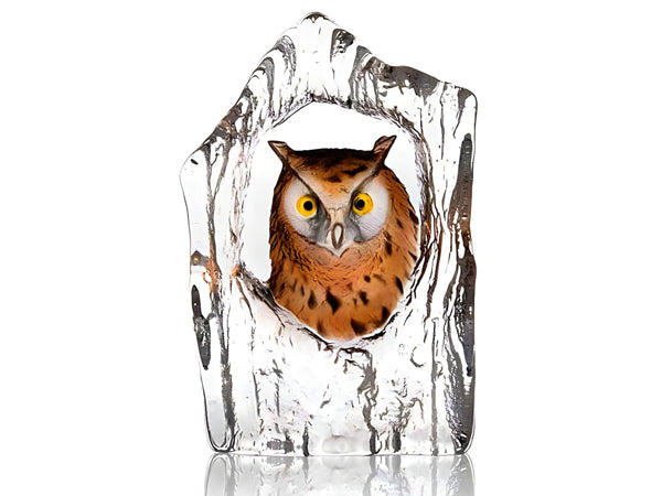 A painted crystal sculpture of an eagle owl peeking through a clear opening, like that of an open tree trunk.