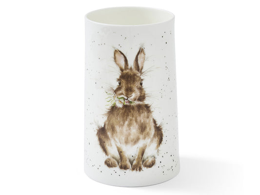 A white, fine bone china vase, with a watercolour illustration of a rabbit snacking on a single daisy and scattered soft speckles across the front.
