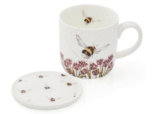 A white mug and coaster set with bee designs and pink flowers