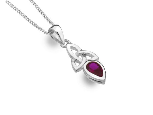A silver necklace with a pendant that has a celtic knot and a red teardrop stone on it