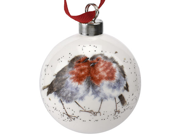 A cream porcelain bauble with a picture of two robins snuggled up against each other on it