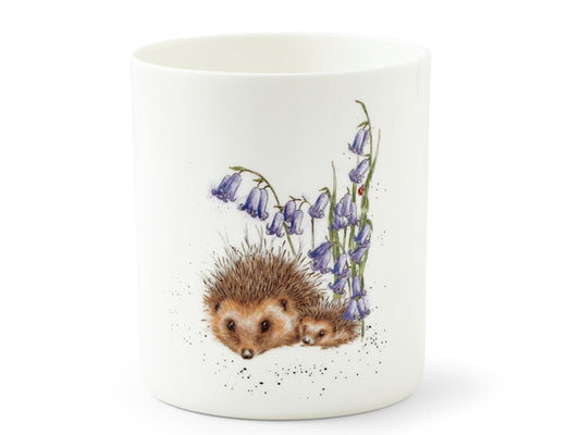 A white, fine bone china utensil jar, with a watercolour illustration of two hedgehogs underneath bluebell flowers.