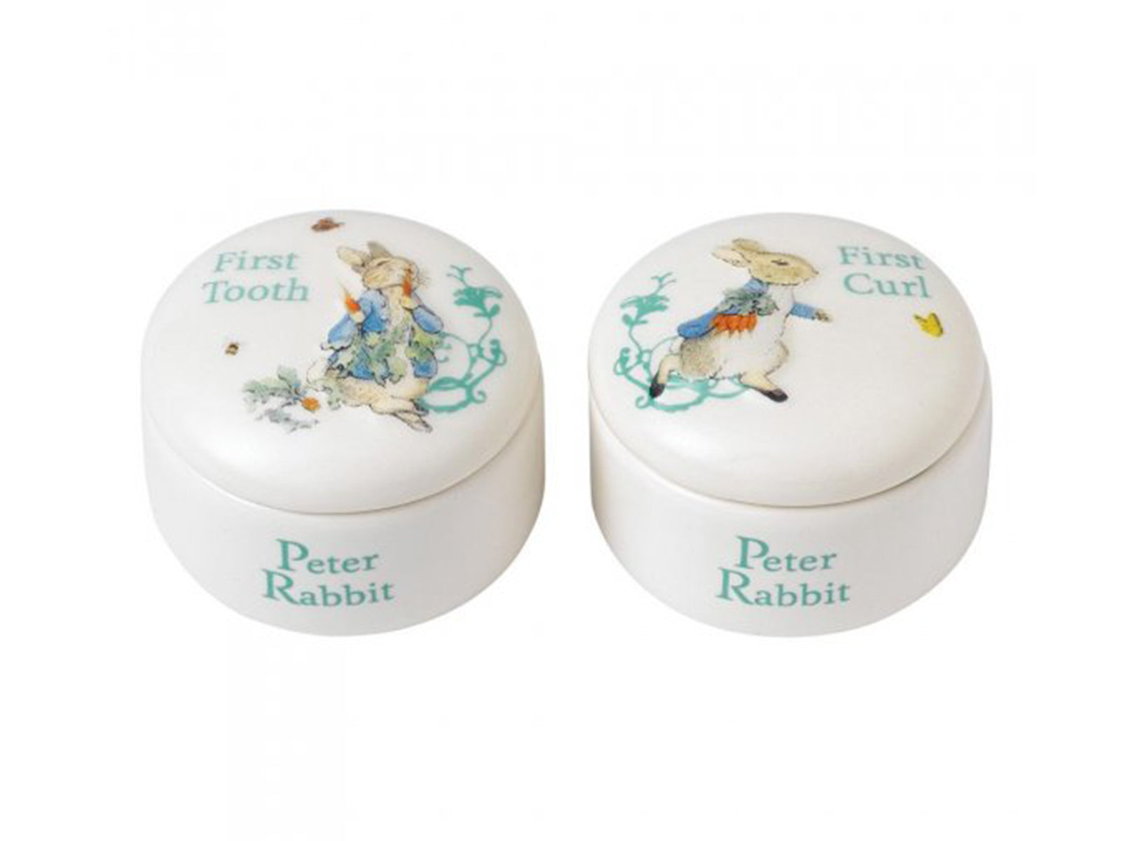 A pair of round porcelain trinket dishes with blue writing and a small brown rabbit wearing a blue jacket decorating the outside.