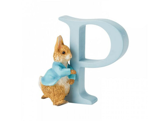 A blue capital letter P with a small brown rabbit in a blue jacket standing next to it