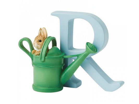 A pastel blue capital letter R with a green watering can in front, with a small brown rabbit popping out of the watering can