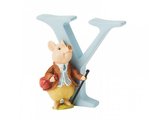 A pastel blue capital letter Y with a white pig in front of it, wearing a brown jacket and trousers, walking with a cane and carrying a red pouch.