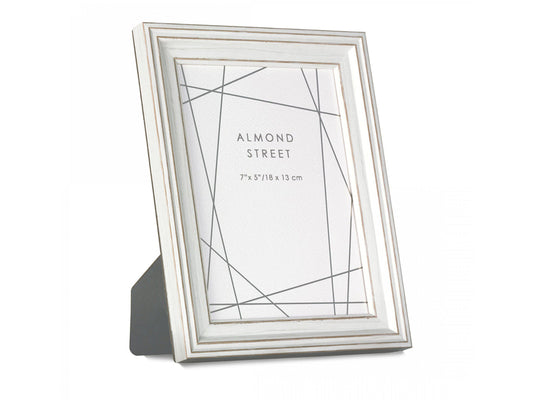 A large white moulded frame with gold detailing