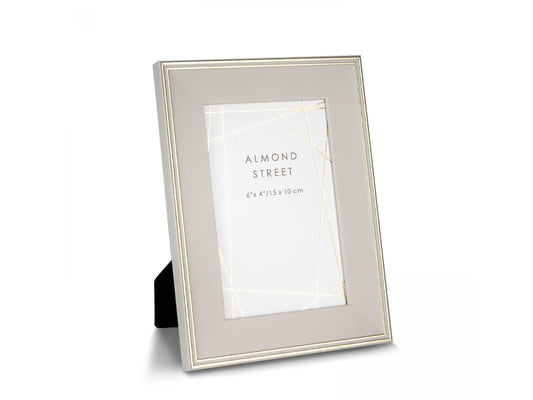 A soft taupe photo frame with gold detailing