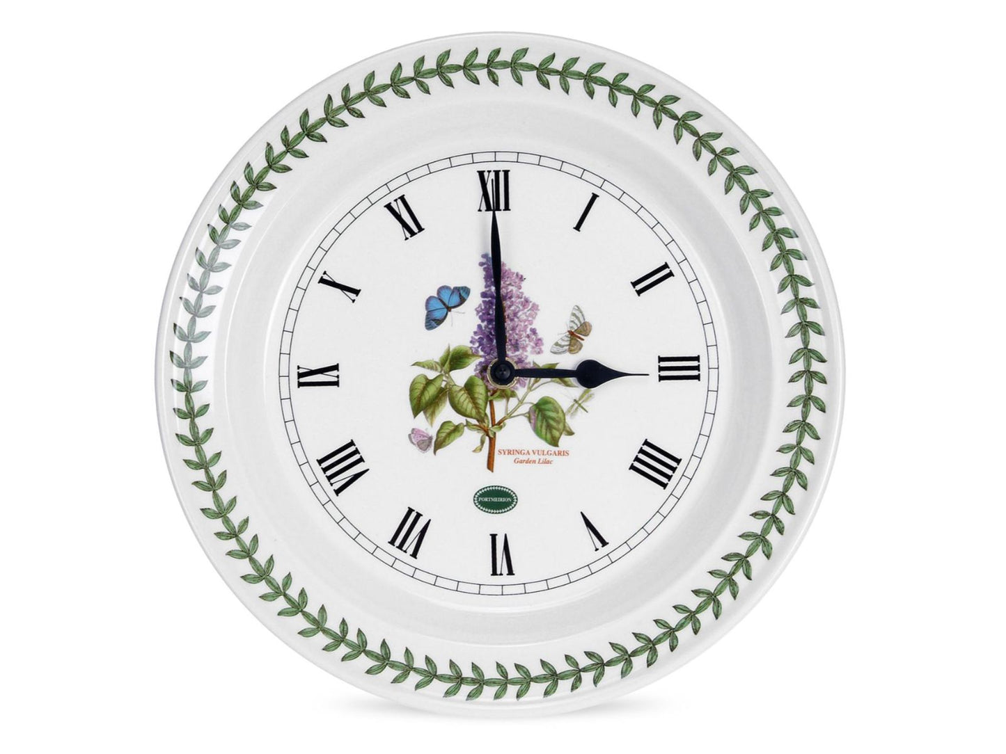 A white porcelain plate with a laurel wreath rim and a lilac design in the centre. The plate has been turned into a clock with black roman numerals around the centre, with matching clock hands affixed in the centre.