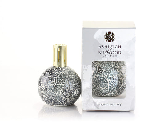 A grey glass fragrance lamp with a rounded mosaic style body and a gold top