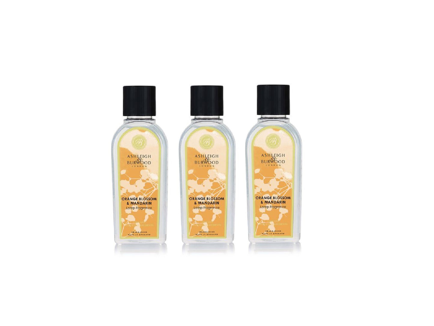 Three clear bottles of lamp liquid with orange floral labels and black caps