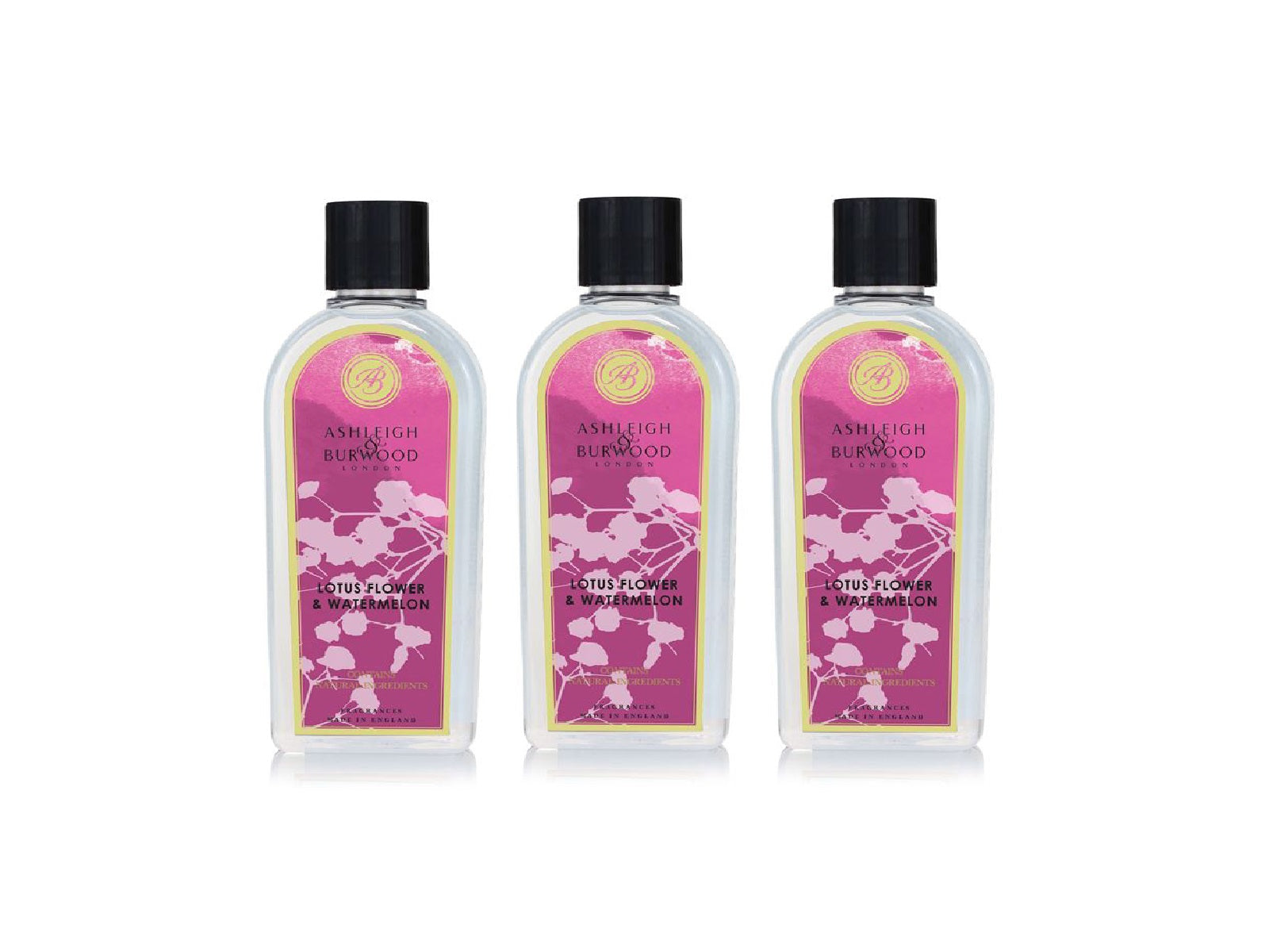 Three bottles of lotus flower and watermelon scented lamp fragrance liquid in clear bottles with pink floral labels and black caps