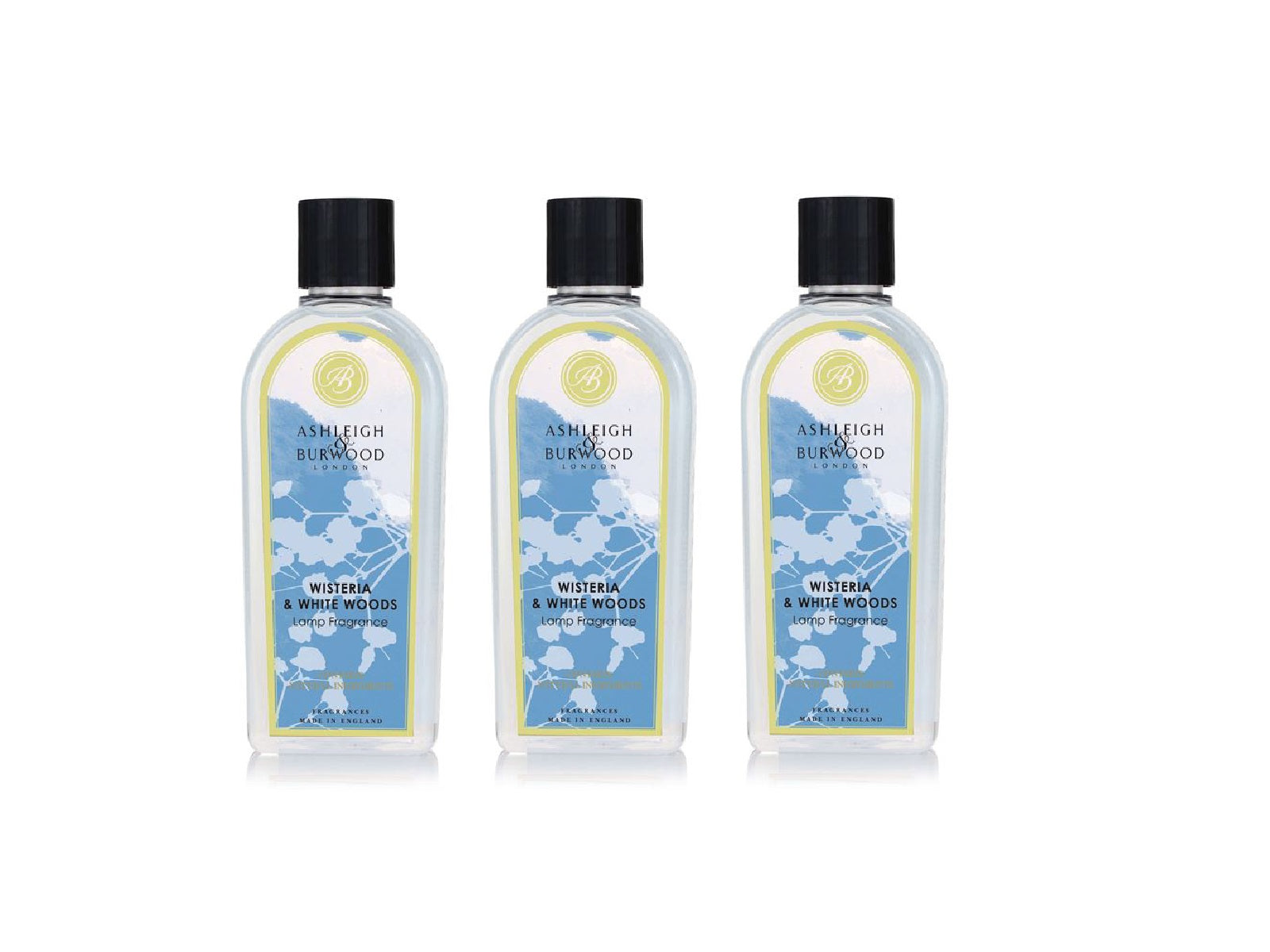 Three bottles of wisteria and white woods fragrance with floral blue labels and black caps