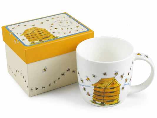 A white ceramic mug with a yellow and brown beehive illustration and small bee motifs, shown next to its matching gift box with a yellow lid and cream body.