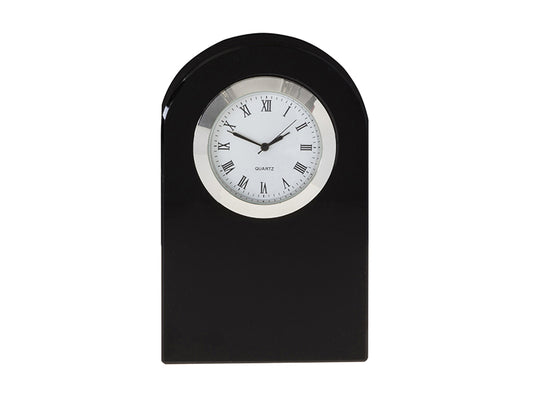 A solid black crystal clock in a dome shape with a clock face set into the top, which is white with a silver rim and black details.