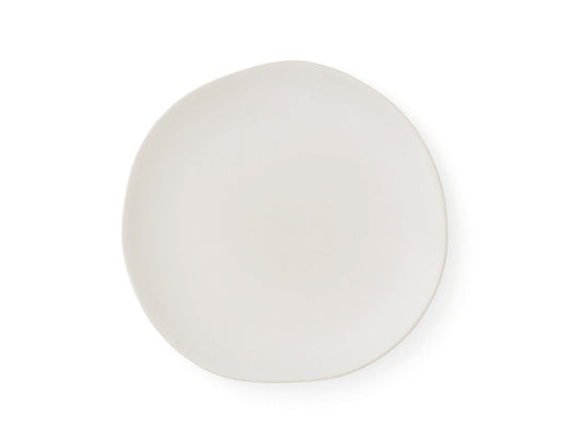 A side plate from Sophie Conran's arbor range. It is cream porcelain that has been finished with a clear glaze, and the edges of the plate are gently flowing unevenly to mimic the natural shapes found in nature.