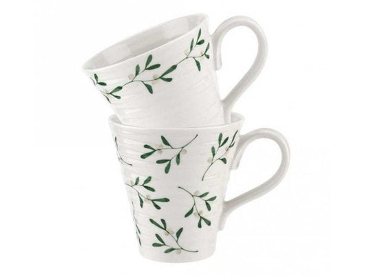 A set of two Sophie Conran mugs that have been designed with her staple rippling effect and printed with individual mistletoe patterns. One has a chain of mistletoe printed around the upper outer rim of the mug, whilst the other has mistletoe sporadically printed all across its exterior.