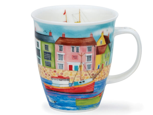 A large fluted fine bone china mug adorned with vibrant seaside illustrations. Coastal homes are shown in lively hues of green, pink, blue, and yellow above a stone harbour wall. Colourful fishing boats gracefully float on blue waters, complemented by a serene blue sky with birds and seagulls. The handle features small seagull illustrations, and the inside rim showcases a charming green fishing boat.