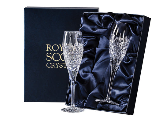 Pair of Royal Scot Crystal Edinburgh Champagne Flutes are hand-cut in Britain with the sophisticated Edinburgh design. They have long, thin stems and a rounded base, and are a perfect anniversary gift.