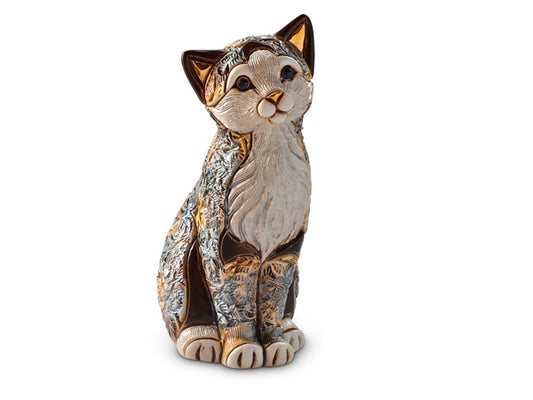 A ceramic figurine of a calico cat, with tri coloured fur, swirls of grey and orange surround white tufts of fur and golden accents adorn the cats ears and nose. The piece is finished in a shimmery enamel glaze.