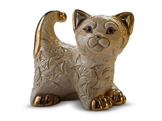 A porcelain white kitten, engraved are spanish shaped fans in its fur. Golden hand painted details adorn its paws, tails & ears