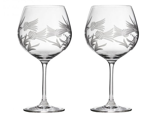 A pair of delicate crystal gin copas, cut with a thistle design that twines around the circumference.