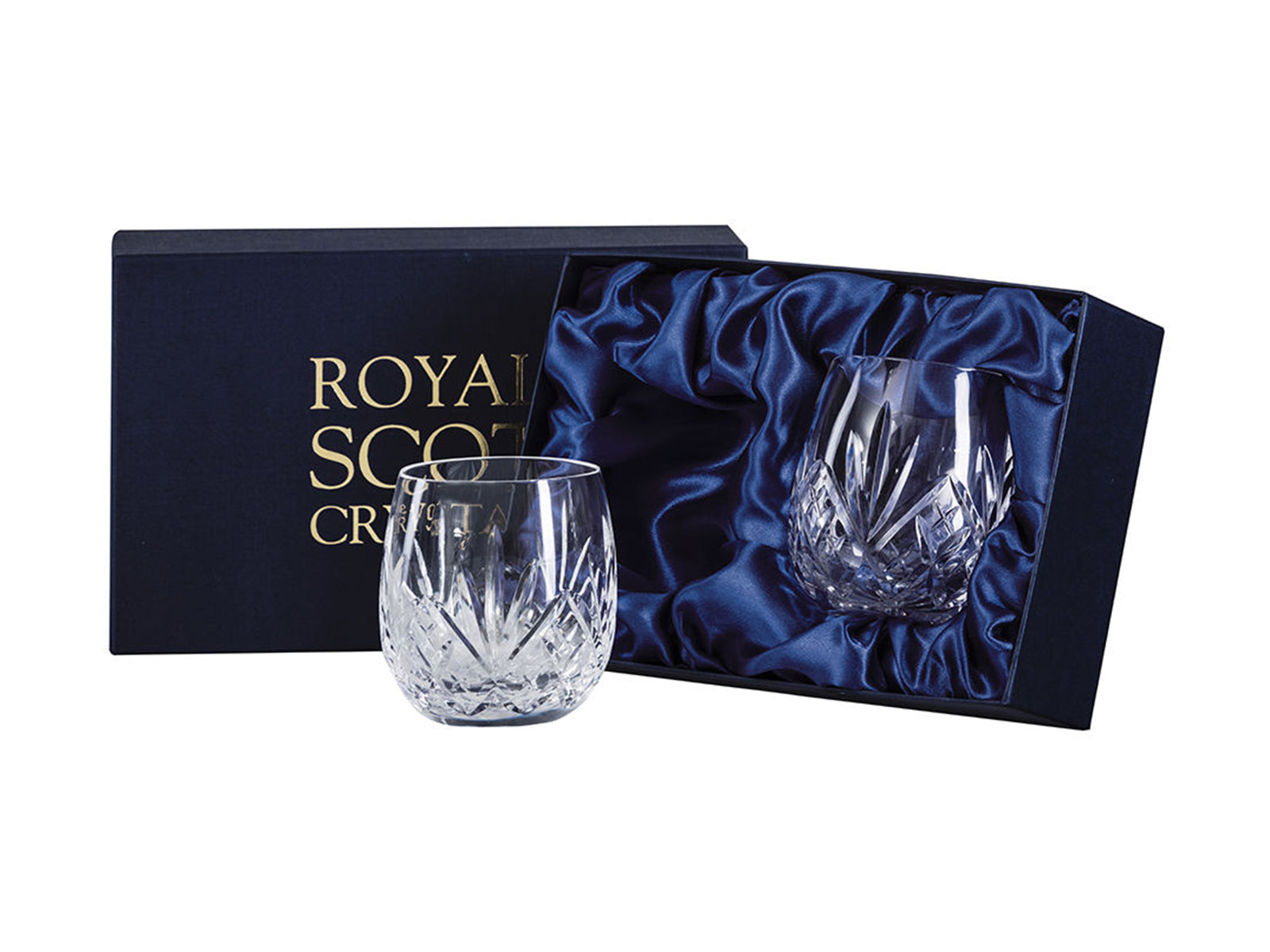 A pair of rounded gin tumblers with a five-pointed fan design over diamonds cut around the base with a smooth rim. They come in a navy-blue silk-lined presentation box with gold branding on the lid.