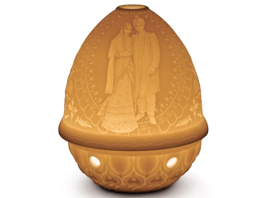 This stunning new edition to the Lladro lithophane collection features an Indian couple on their wedding day . Perfectly complimenting the lavish and luxurious occassion, the bride is wearing the traditional lehenga and the groom a sherwani as they hold hands in a sign of unity and an everlasting bond. This beautiful pattern is perfectly captured in the intricate etching of the translucent lithophane, making a stunning addition to any lithophane collection.
